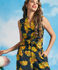 Woman posing in black tropical print tie-front sleeveless blouse with convertible collar