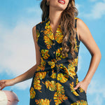 Woman posing in black tropical print tie-front sleeveless blouse with convertible collar