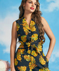 Woman wearing retro tropical sleeveless button-front shirt with tie hem detail