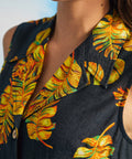 Close-up of convertible collar and tropical leaf print on sleeveless retro shirt