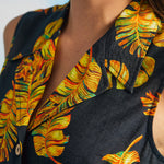 Close-up of convertible collar and tropical leaf print on sleeveless retro shirt