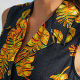 Close-up of convertible collar and tropical leaf print on sleeveless retro shirt