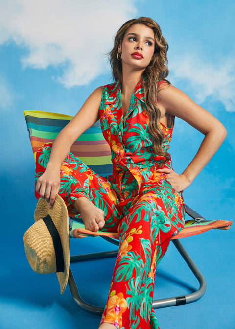 Woman lounging in tropical print retro resort outfit with tie-front top