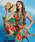 Woman wearing tropical print sleeveless tie-front shirt in Tropical Punch