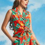 Woman wearing vibrant tropical print sleeveless top with high-waisted matching pants