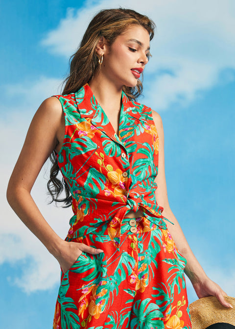 Woman wearing vibrant tropical print sleeveless top with high-waisted matching pants