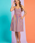 Model wearing retro-inspired multicolor stripe midi dress with pockets