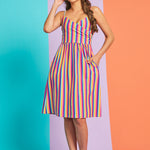 Model wearing retro-inspired multicolor stripe midi dress with pockets