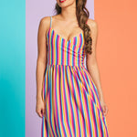 Woman wearing rainbow stripe sleeveless midi dress with surplice neckline and pockets