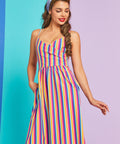 Model posing in colorful retro stripe midi dress with side pockets