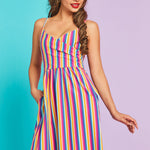 Model posing in colorful retro stripe midi dress with side pockets