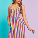 Model posing in colorful retro stripe midi dress with side pockets