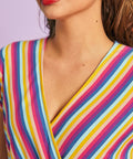 Close-up of faux-wrap neckline on rainbow stripe retro-inspired jumpsuit