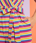 Close-up detail of tie waist and side pocket on colorful striped jumpsuit