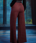Back view of woman wearing red tartan plaid wide leg pants showing the elasticized back waist and full-length wide-leg silhouette