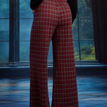 Back view of woman wearing red tartan plaid wide leg pants showing the elasticized back waist and full-length wide-leg silhouette