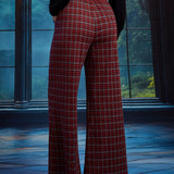 Back view of woman wearing red tartan plaid wide leg pants showing the elasticized back waist and full-length wide-leg silhouette