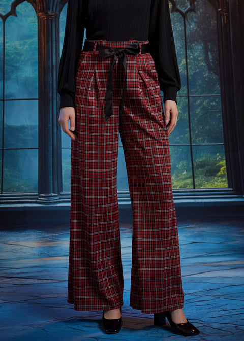Front view of red tartan plaid wide leg pants showing the high waist, front pleats, black sash belt, and full-length legs
