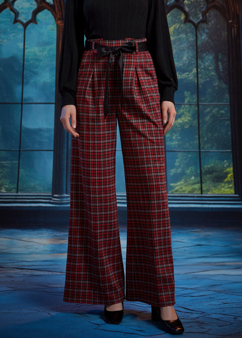 Front view of woman wearing red tartan plaid wide leg pants with black sash belt, showing the pleated waist and wide-leg fit
