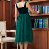 Back view of emerald green velvet tulle midi dress showing square back and zipper