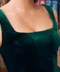 Close-up of emerald green velvet square neckline and princess seam bodice