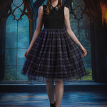 A young woman stands in a gothic-style room with large arched windows, wearing a sleeveless dress with black top and a full black-and-purple plaid skirt with a patterned collar and black boots.