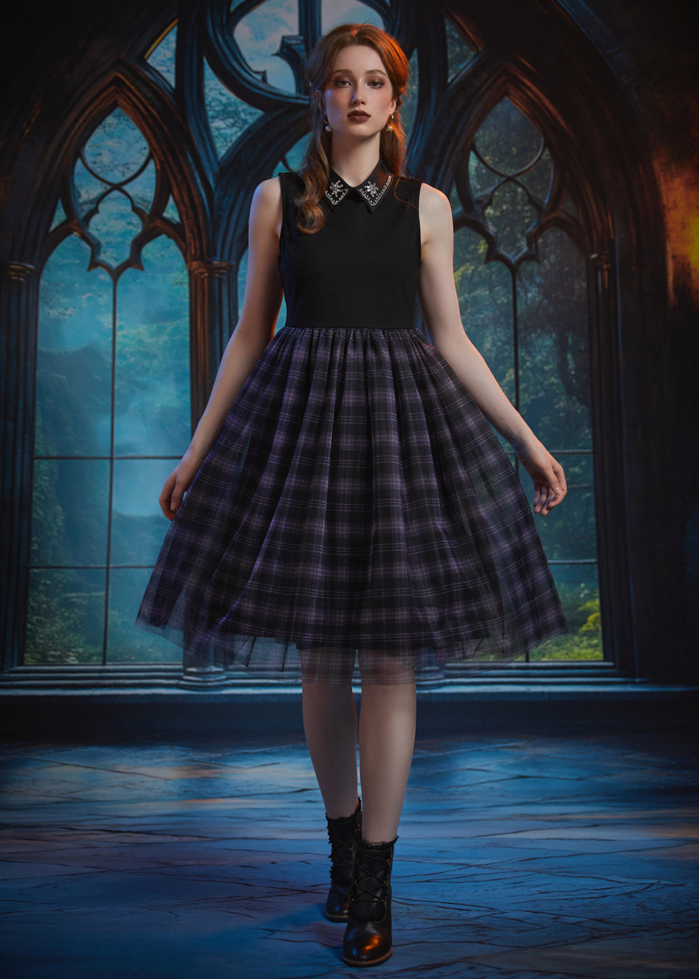 A young woman stands in a gothic-style room with large arched windows, wearing a sleeveless dress with black top and a full black-and-purple plaid skirt with a patterned collar and black boots.
