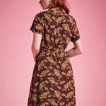 Back view of brown floral short sleeve shirt dress with flowing silhouette