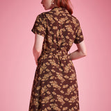 Back view of brown floral short sleeve shirt dress with flowing silhouette
