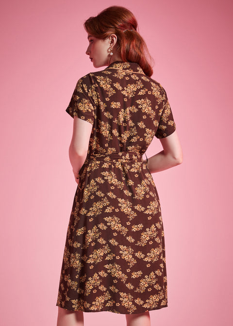 Back view of brown floral short sleeve shirt dress with flowing silhouette