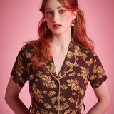 Brown floral viscose shirt dress with full button-front closure and vintage-inspired silhouette