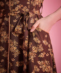 Front slant pocket detail on brown floral dress with removable self-tie belt