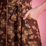 Front slant pocket detail on brown floral dress with removable self-tie belt