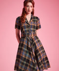 Woman wearing ModCloth Rustic Elegance Casual Dress in Harvest Tartan with removable buckle belt