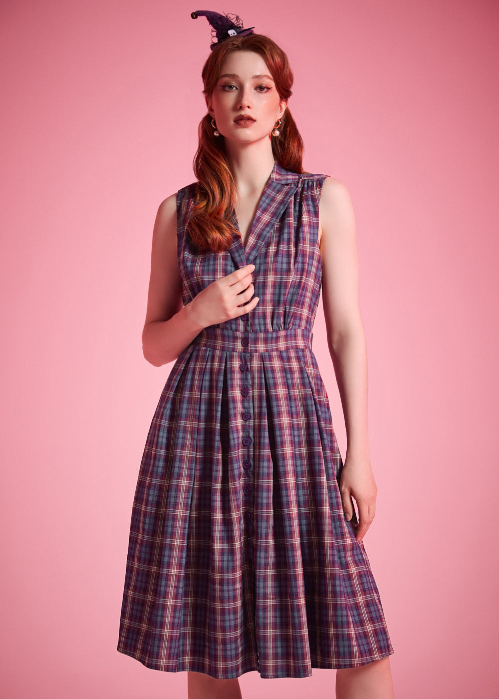 Sleeveless vintage-inspired plaid dress with functional button-front closure and side pockets
