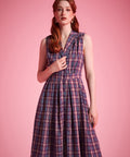 Sleeveless vintage-inspired plaid dress with functional button-front closure and side pockets