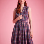 Sleeveless vintage-inspired plaid dress with functional button-front closure and side pockets