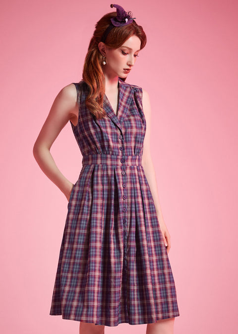 Woman wearing ModCloth Carousel Cutie sleeveless plaid fit-and-flare dress