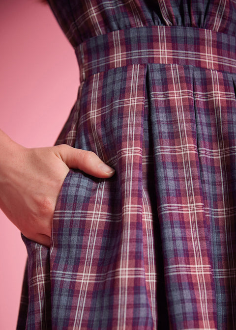 Close-up of plaid fabric dress with hidden side seam pockets