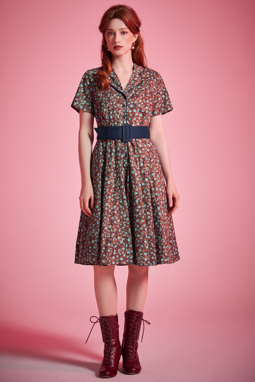 Woman wearing vintage-inspired floral fit-and-flare dress styled with lace-up boots