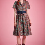 Woman wearing vintage-inspired floral fit-and-flare dress styled with lace-up boots