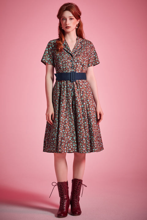 Woman wearing vintage-inspired floral fit-and-flare dress styled with lace-up boots