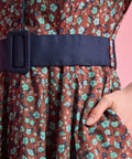 Side pocket and removable navy buckle belt detail on floral cotton dress