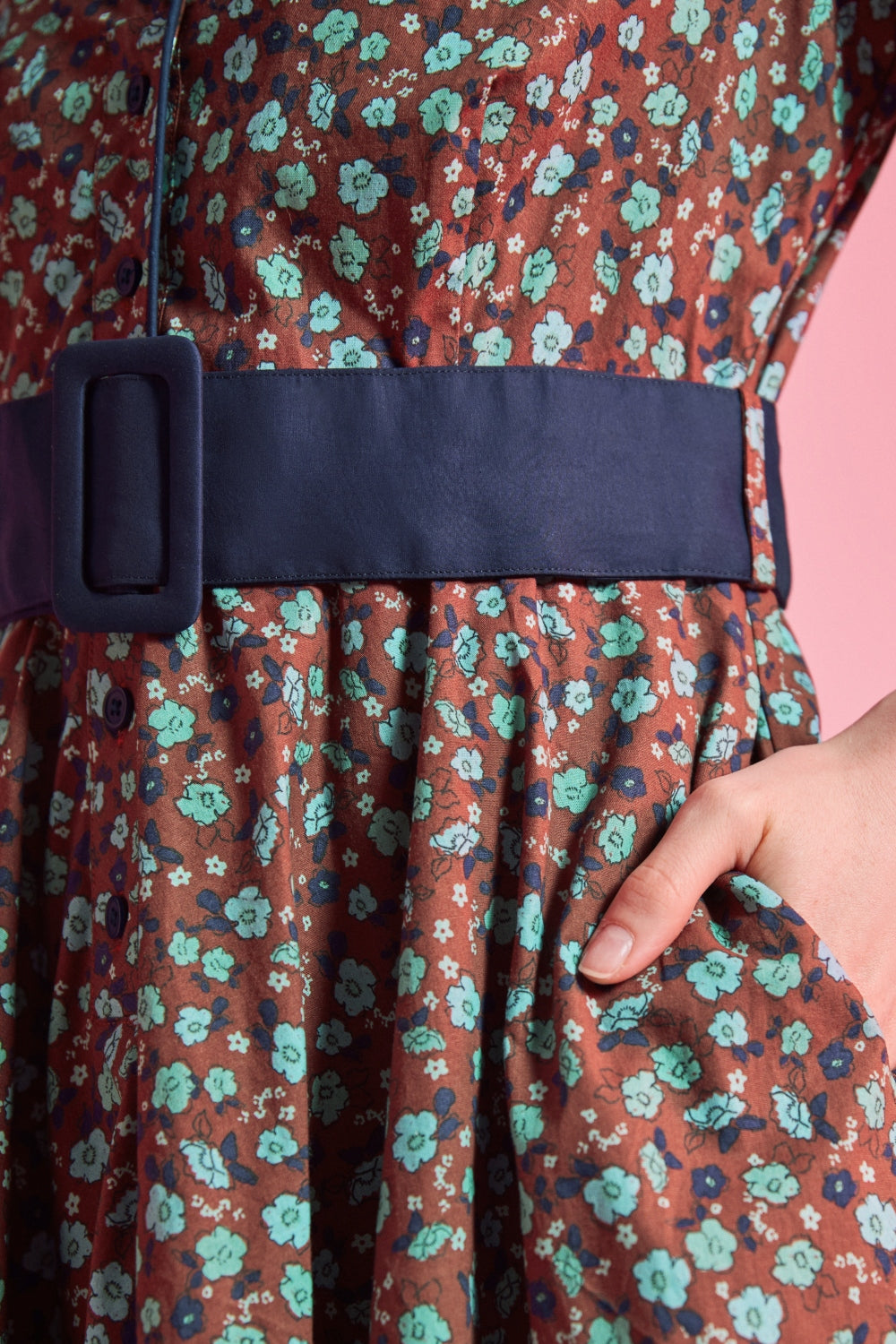 Side pocket and removable navy buckle belt detail on floral cotton dress