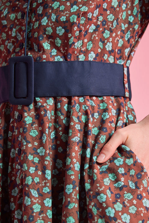 Side pocket and removable navy buckle belt detail on floral cotton dress