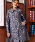 Woman wearing purple gothic brocade midi coat with oversized collar and metallic buttons