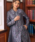 Woman wearing vintage gothic brocade coat with bats moons and ornate botanical pattern