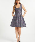 Woman wearing purple gothic fit and flare dress with ornate bat crescent moon print