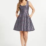 Woman wearing purple gothic fit and flare dress with ornate bat crescent moon print