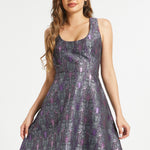 Woman wearing dark academia fit and flare dress with purple bat and moon pattern